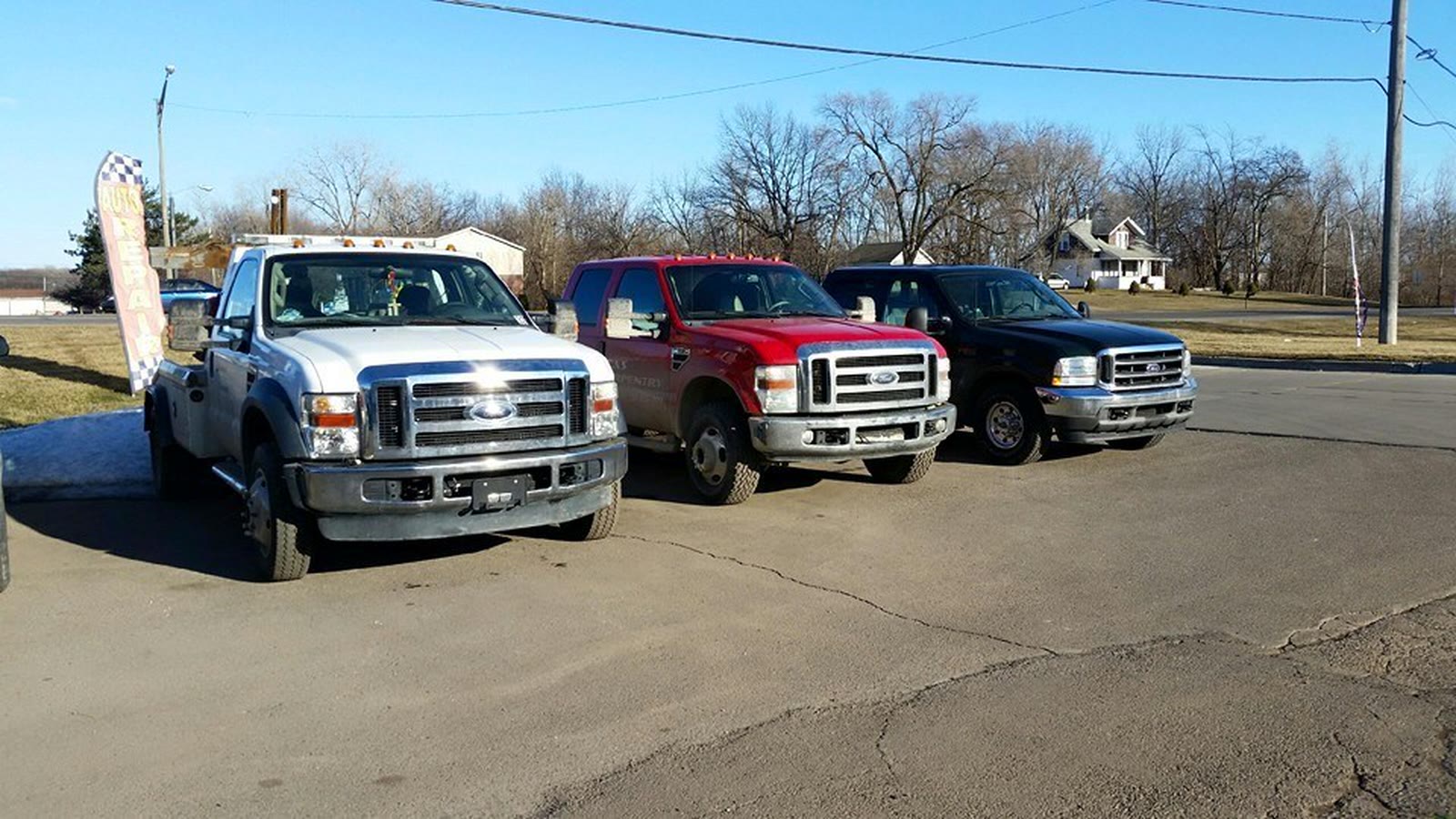 Three Ford Super Duty work trucks parked on the Winners Diesel lot in Brownstown